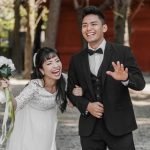 smiley-newlyweds-waving-having-fun-their-wedding-day_23-2148746649